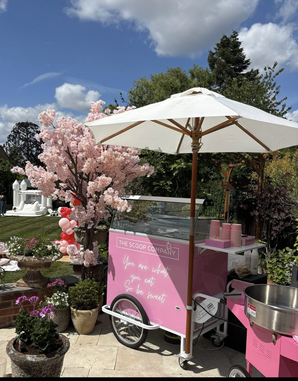 The Scoop Company's pink gelato cart set up at a garden event